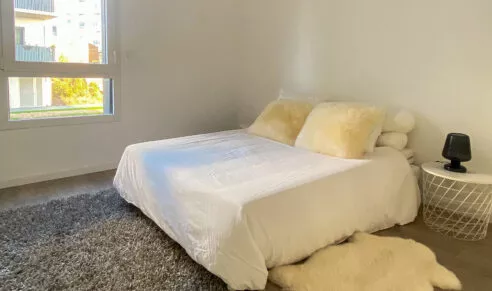 Chambre avec un lit double d'un appartement neuf à Rennes, dans la résidence Brownstone.